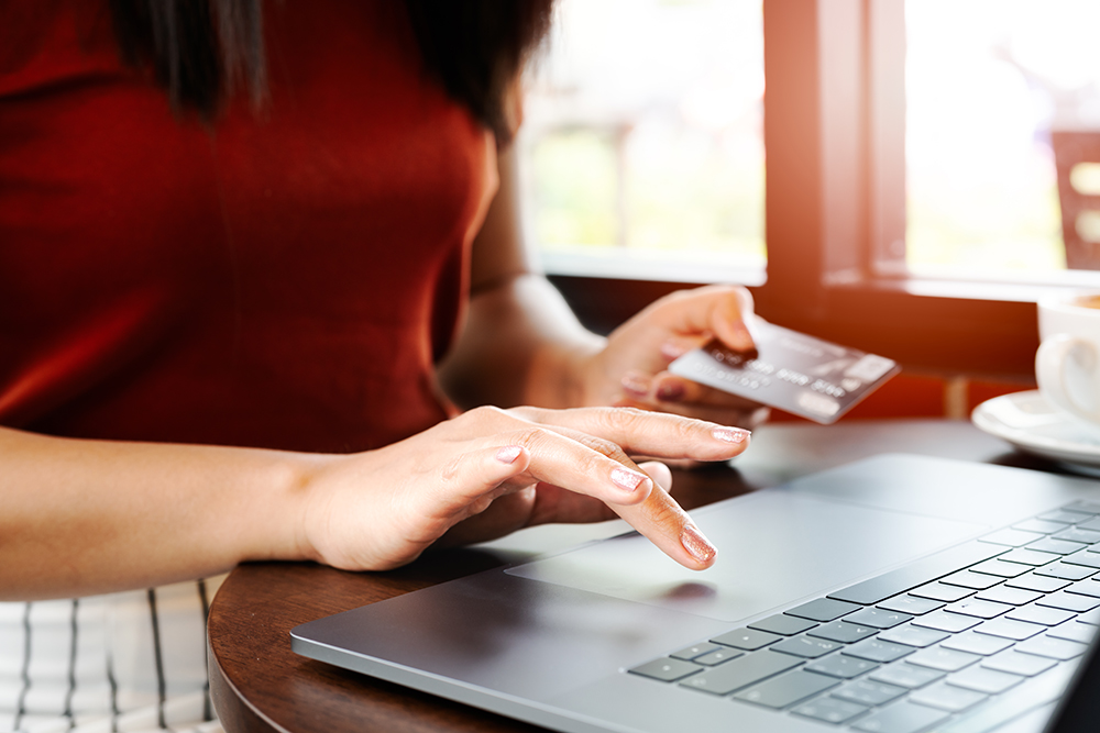 woman-hands-holding-credit-card-using-laptop-online-shopping